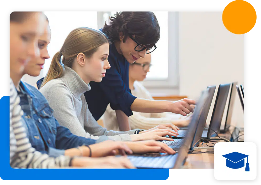 An instructor guiding her student on her laptop with the entire class
